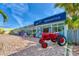 Unique Mercantile storefront with a vintage red tractor parked out front, adding rustic charm to the business at 1183 Cedar Ave, Englewood, FL 34223