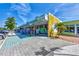 Vibrant storefront featuring colorful awnings, displays, and a brick sidewalk, creating an inviting commercial space at 1183 Cedar Ave, Englewood, FL 34223