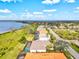 Aerial view showcases homes with waterfront views and screened-in pools along a scenic coastline at 14026 Royal Pointe Dr, Port Charlotte, FL 33953