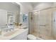 The bathroom boasts a sink, vanity, shower with glass doors and white trim at 14026 Royal Pointe Dr, Port Charlotte, FL 33953