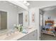 Bright bathroom featuring double sinks, a large mirror and decorative artwork on the wall at 14026 Royal Pointe Dr, Port Charlotte, FL 33953