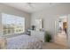 This well-lit bedroom offers a large window and view into the kitchen at 14026 Royal Pointe Dr, Port Charlotte, FL 33953