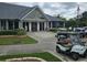 A view of the clubhouse surrounded by golf carts at 14026 Royal Pointe Dr, Port Charlotte, FL 33953