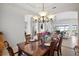 Elegant dining room featuring tray ceilings, an ornate chandelier, and seating for six at 14026 Royal Pointe Dr, Port Charlotte, FL 33953