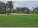 Putting green with flags and golfers in a community golf course at 14026 Royal Pointe Dr, Port Charlotte, FL 33953