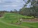 Rolling hills and lush greenery define the golf course landscape at 14026 Royal Pointe Dr, Port Charlotte, FL 33953
