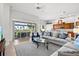 Bright living room boasts neutral tones, sliding doors to the lanai, and an open floor plan at 14026 Royal Pointe Dr, Port Charlotte, FL 33953