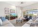 Comfortable living room offers plush seating, a large TV, and access to the outdoor space at 14026 Royal Pointe Dr, Port Charlotte, FL 33953