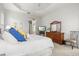 Bright main bedroom features neutral walls and carpet, ceiling fan, and a view into the main bathroom at 14026 Royal Pointe Dr, Port Charlotte, FL 33953