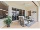 Outdoor patio featuring comfortable seating, ceiling fan, and a screened-in view of the lake at 14026 Royal Pointe Dr, Port Charlotte, FL 33953