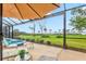 Outdoor patio featuring comfortable seating, a nearby pool, and a view of the lake at 14026 Royal Pointe Dr, Port Charlotte, FL 33953