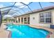 Backyard pool and patio area with comfortable seating and scenic views of the surrounding landscape at 14026 Royal Pointe Dr, Port Charlotte, FL 33953