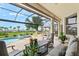Resort-style pool and patio with ample seating, a covered lanai, and scenic views at 14026 Royal Pointe Dr, Port Charlotte, FL 33953