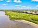 Aerial view of waterfront properties with lush green spaces and picturesque views at 14026 Royal Pointe Dr, Port Charlotte, FL 33953