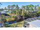 Backyard canal view featuring a screened-in pool and lush landscaping from above at 14157 Kewanee Ln, Port Charlotte, FL 33981