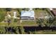 Aerial view of a house with a screened-in pool, a waterfront view, and outdoor seating at 14157 Kewanee Ln, Port Charlotte, FL 33981
