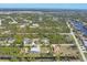 Aerial view of homes in a lush community with access to canals and waterways at 14157 Kewanee Ln, Port Charlotte, FL 33981