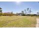 Expansive backyard with lush grass, mature trees, and ample space for outdoor activities at 14157 Kewanee Ln, Port Charlotte, FL 33981