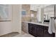 Bathroom vanity with dark wood cabinets, granite countertop, and decorative beach-themed accents at 14157 Kewanee Ln, Port Charlotte, FL 33981