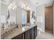 Bathroom featuring double vanity with granite countertop, and tiled shower with fish decor at 14157 Kewanee Ln, Port Charlotte, FL 33981