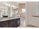 Bathroom vanity featuring dark wood cabinets, granite countertop, tile backsplash, and decorative elements at 14157 Kewanee Ln, Port Charlotte, FL 33981