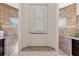Bathroom niche with decorative artwork, granite shelf, and adjacent vanities at 14157 Kewanee Ln, Port Charlotte, FL 33981