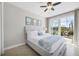 Calm bedroom featuring light wood furniture and a sliding glass door to an outdoor patio at 14157 Kewanee Ln, Port Charlotte, FL 33981