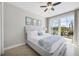 Bedroom with a ceiling fan and a sliding glass door to the patio at 14157 Kewanee Ln, Port Charlotte, FL 33981