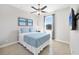 Cozy bedroom with tiled floors, ceiling fan, and large window at 14157 Kewanee Ln, Port Charlotte, FL 33981