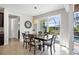 Dining room with wood table and chairs, overlooking the screened in pool area at 14157 Kewanee Ln, Port Charlotte, FL 33981