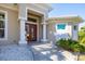 Close up view of the front door and entryway with stately columns and stone landscaping at 14157 Kewanee Ln, Port Charlotte, FL 33981