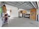 A spacious and well-organized garage includes a workbench, storage, and parking for a vehicle at 14157 Kewanee Ln, Port Charlotte, FL 33981