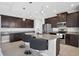 Modern kitchen featuring an island, granite countertops, and stainless steel appliances at 14157 Kewanee Ln, Port Charlotte, FL 33981