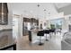 Open kitchen features an island with seating, dark wood cabinets, and stainless steel appliances at 14157 Kewanee Ln, Port Charlotte, FL 33981