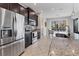 Modern kitchen with granite countertops, stainless steel appliances, and dark wood cabinetry at 14157 Kewanee Ln, Port Charlotte, FL 33981