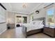 Main bedroom featuring a neutral paint palette, tray ceiling, and access to the outdoors at 14157 Kewanee Ln, Port Charlotte, FL 33981