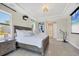 Comfortable main bedroom with a tray ceiling, neutral paint, and a modern ceiling fan at 14157 Kewanee Ln, Port Charlotte, FL 33981