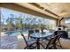 The outdoor dining area features a glass-topped table, comfortable chairs, and a ceiling fan for outdoor dining at 14157 Kewanee Ln, Port Charlotte, FL 33981