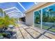The patio is screened-in with a view of the pool, lake, and backyard at 14157 Kewanee Ln, Port Charlotte, FL 33981