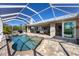 Enclosed pool area with outdoor kitchen, bar, sitting area, and a screen enclosure at 14157 Kewanee Ln, Port Charlotte, FL 33981
