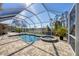 Screened-in pool area with jacuzzi and brick pavers at 14157 Kewanee Ln, Port Charlotte, FL 33981