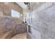 Tiled walk-in shower featuring a built-in bench, niche and dual shower head at 14157 Kewanee Ln, Port Charlotte, FL 33981