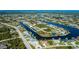 Elevated view of waterfront homes situated on canals that stretch to the Gulf, amidst a tree-lined residential community at 14718 San Domingo Blvd, Port Charlotte, FL 33981
