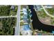 Elevated view captures canal-front houses featuring screened lanai's, providing insight into the layout of backyard spaces at 14718 San Domingo Blvd, Port Charlotte, FL 33981