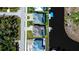 Birds eye view showcases canal-front houses with screened in lanai's, offering a unique perspective of backyard amenities at 14718 San Domingo Blvd, Port Charlotte, FL 33981