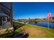 Waterfront backyard with canal views, dock, lush lawn, and mature landscaping at 14718 San Domingo Blvd, Port Charlotte, FL 33981