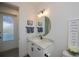 Bright bathroom with a vessel sink vanity, framed mirror, and decorative towels at 14718 San Domingo Blvd, Port Charlotte, FL 33981