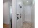 Sleek walk-in shower with gray stone pebble flooring, a glass door, and integrated storage niches at 14718 San Domingo Blvd, Port Charlotte, FL 33981