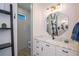 Elegant bathroom featuring a walk-in shower, vanity with a marble countertop, and stylish mirror and fixtures at 14718 San Domingo Blvd, Port Charlotte, FL 33981
