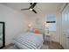 Bright bedroom with a ceiling fan, a comfortable bed, and stylish coastal-themed décor at 14718 San Domingo Blvd, Port Charlotte, FL 33981